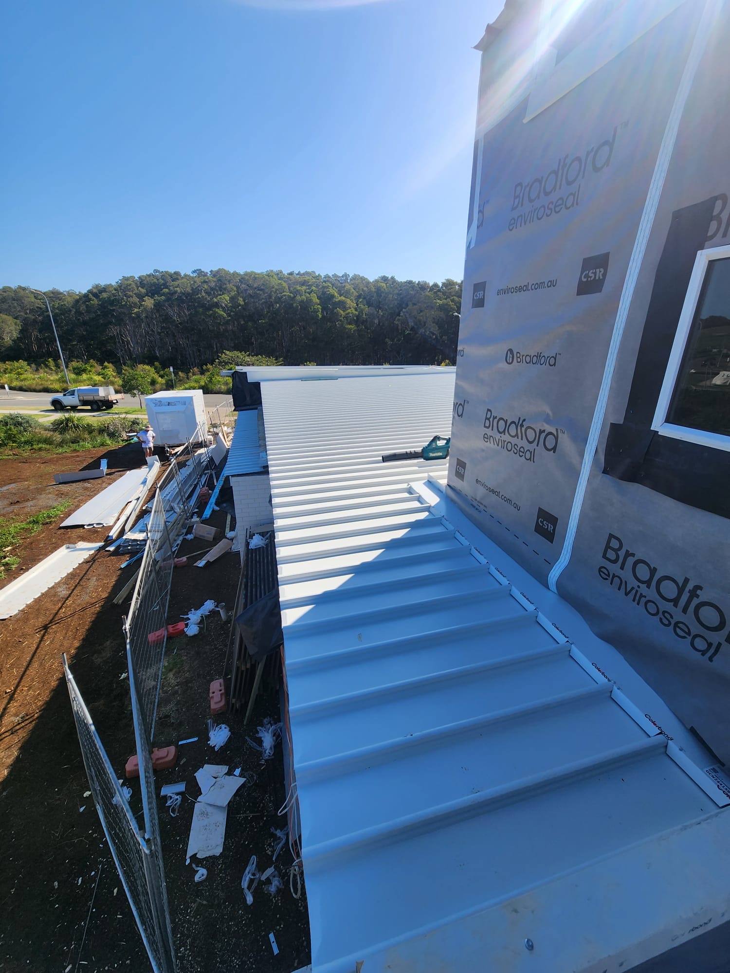 Metal roofing meeting the side of a building under construction
