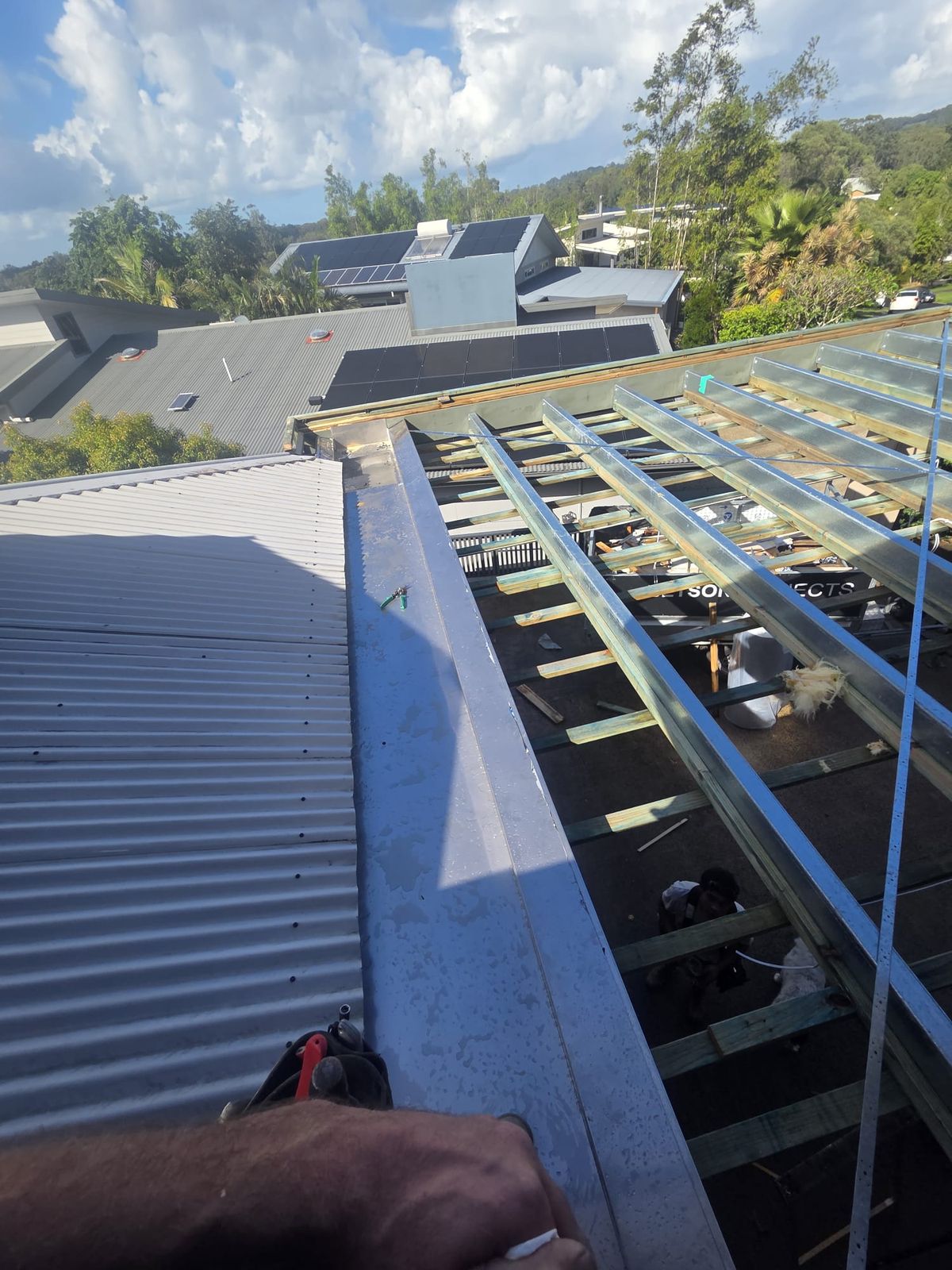 Carport roof stripped back to steel battens with flashing