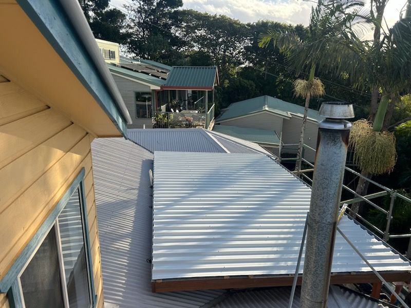 New corrugated metal roof over a timber pergola