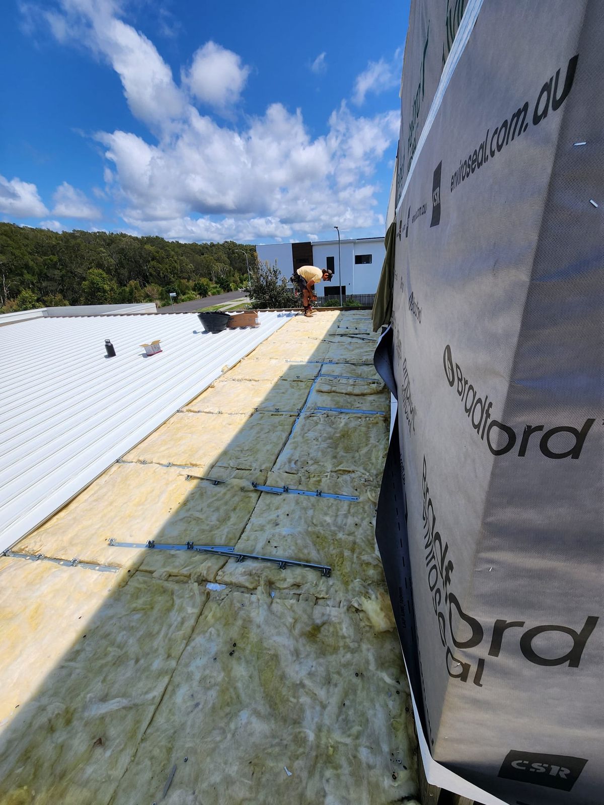 Insulation blanket and metal sheeting being laid