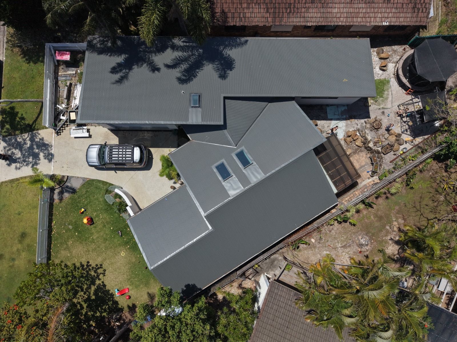 Top down view of the dark grey metal roof with three skylights