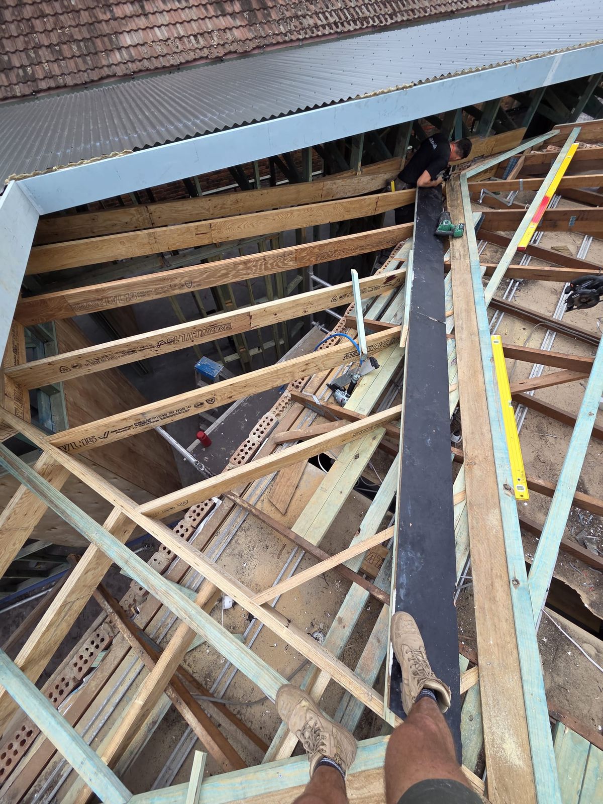 Roof framing meeting the edge of the new metal sheeting